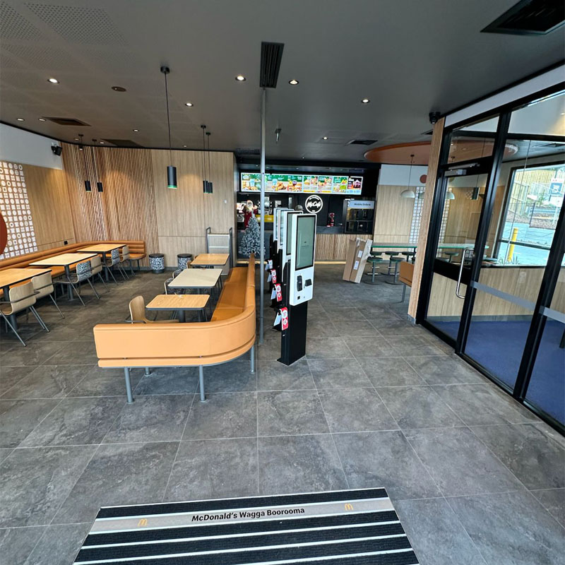 Grey floor tiles in a McDonald's dining area with orange booth seating
